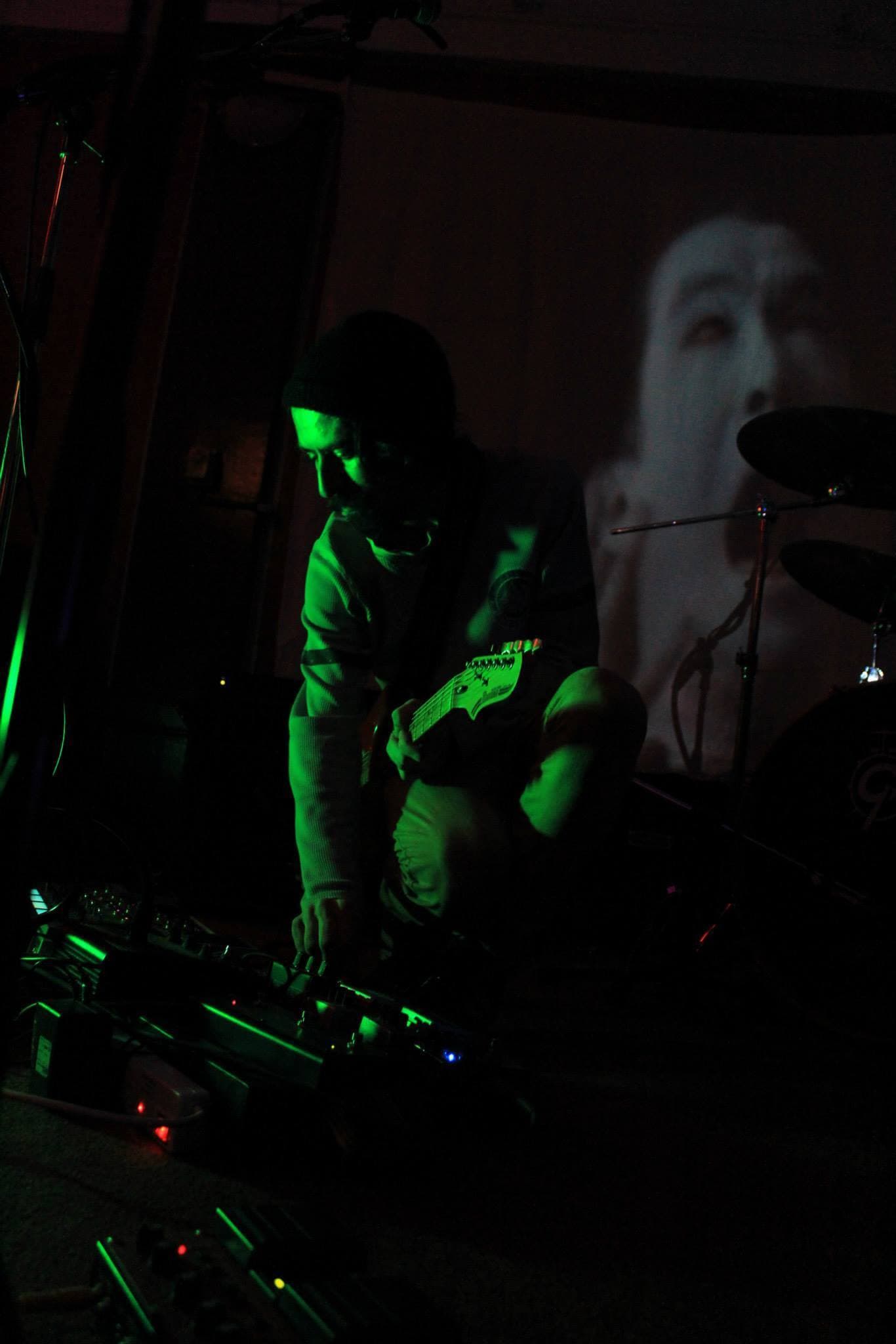 Brendan playing guitar live on stage.