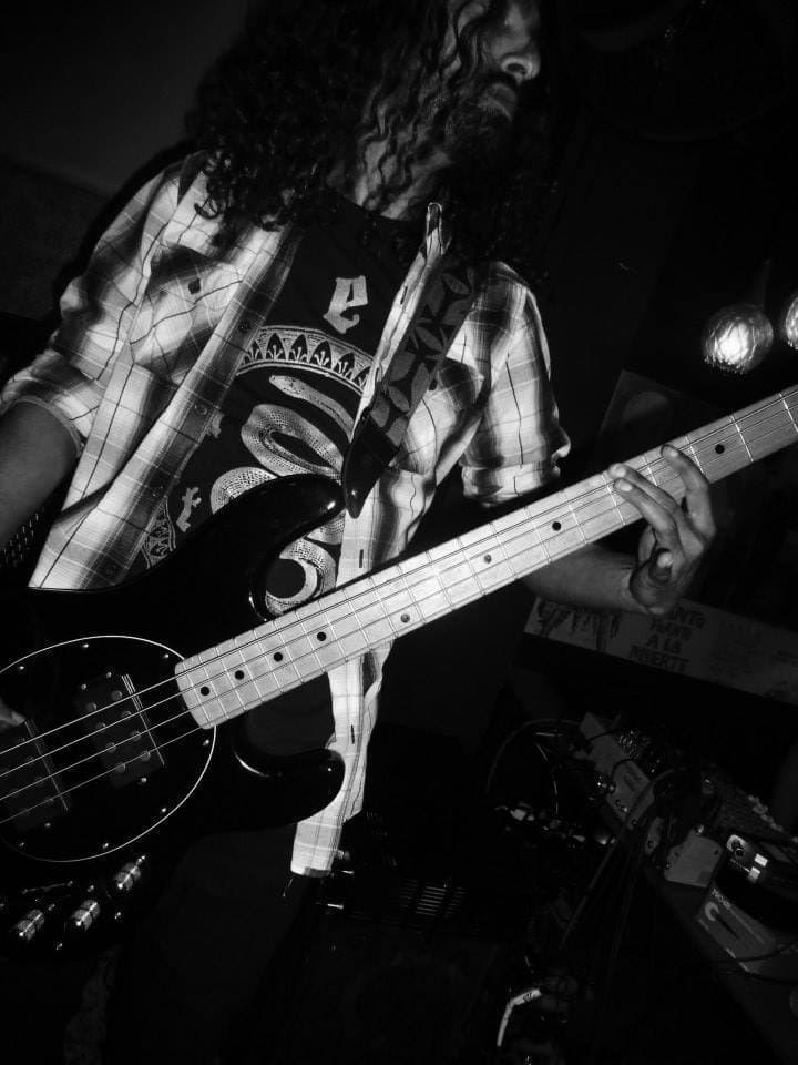 Vitesh playing bass live on stage.